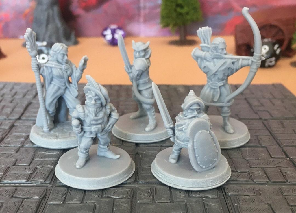 Miniaturas de personagens de fantasia sobre um mapa quadriculado de RPG